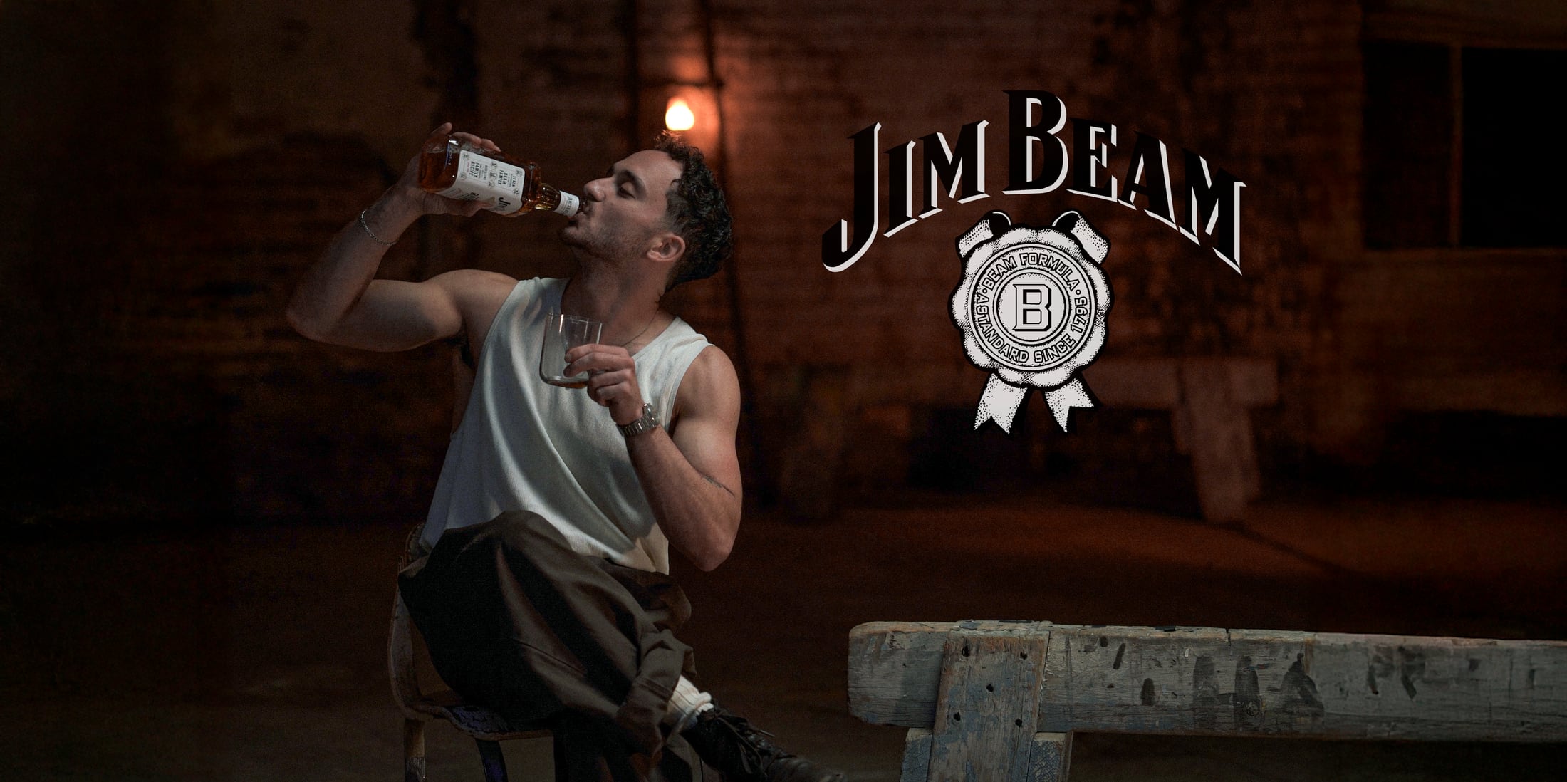 Jim Beam commercial still with a man holding a bottle.