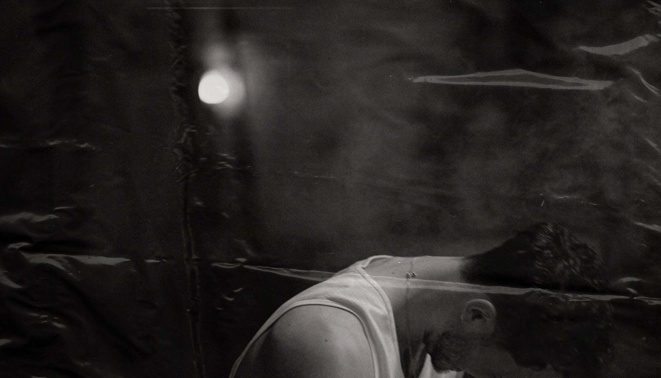 Black-and-white Jim Beam still of a man leaning forward.