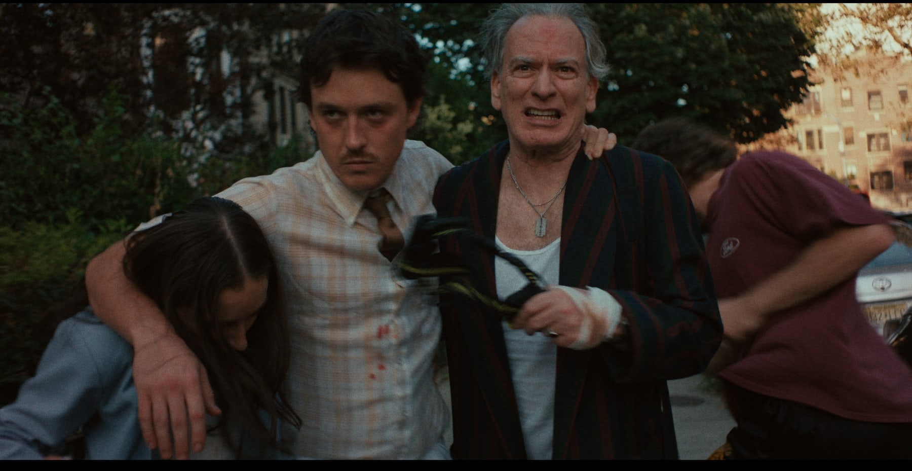 Toy Gun still with characters moving through outdoor chaos.