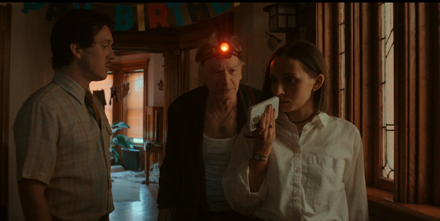 Toy Gun still with characters gathered around a phone call.